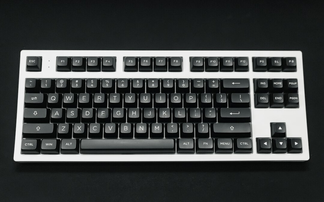 Hands typing on a laptop keyboard